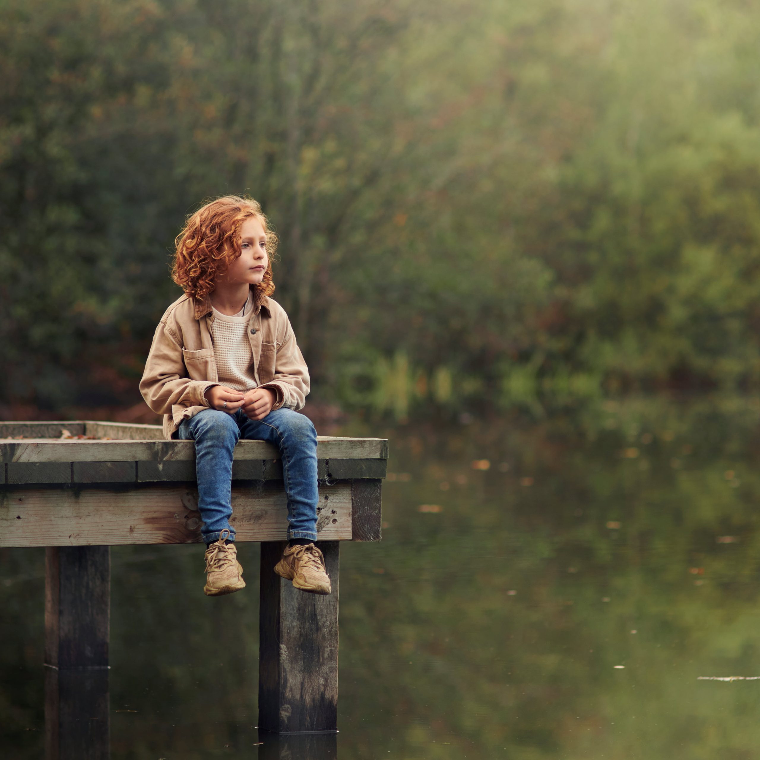 Dreamy fine art portrait of a child by the lake, fairy tale style